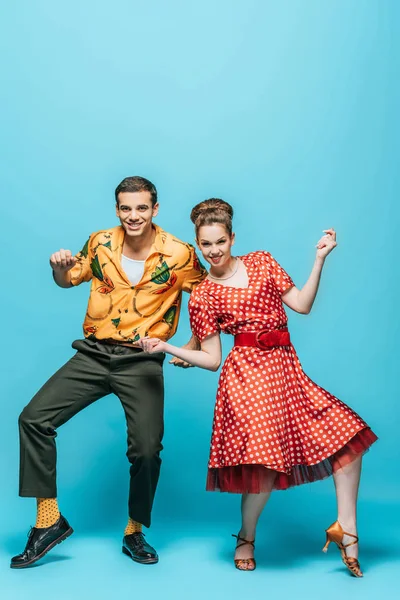 Cheerful Dancers Looking Camera While Dancing Boogie Woogie Blue Background — 스톡 사진