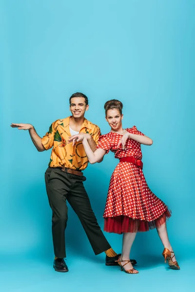 Stylish Dancers Looking Camera While Dancing Boogie Woogie Blue Background — Stock Photo, Image