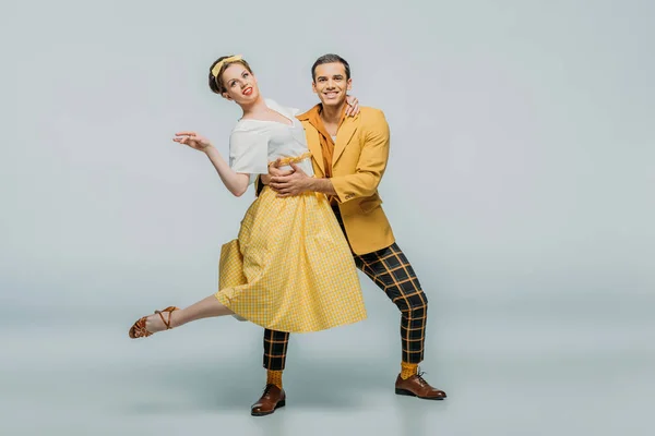 Smiling Dancers Looking Camera While Dancing Boogie Woogie Grey Background — Stock Photo, Image