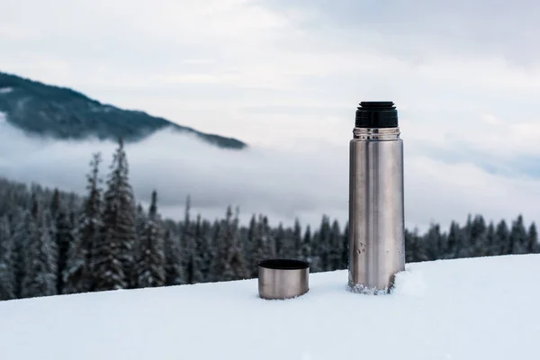 Open Metallic Vacuum Flask Snowy Mountains Pine Trees White Fluffy — Stock Photo, Image