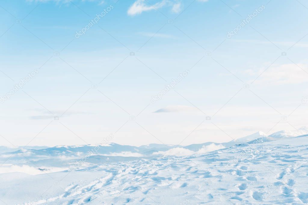 scenic view of snowy mountain with traces and pure blue sky