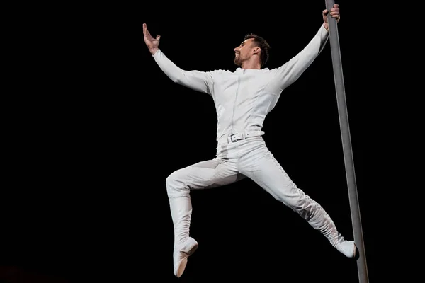 Strong Acrobat Posing While Performing Holding Metallic Pole Isolated Black — 스톡 사진