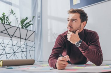 pensive scrum master looking away while holding marker pen  clipart