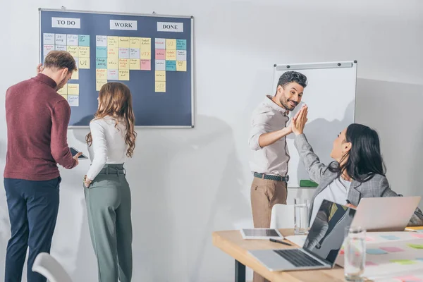 Happy Mixed Race Man Giving High Five Asian Businesswoman Scrum — Stock Photo, Image