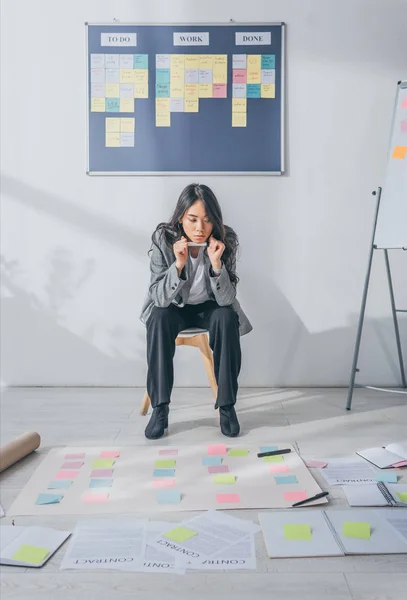 Pensive Asian Scrum Master Sitting Chair Looking Sticky Notes — 스톡 사진