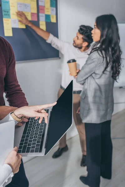 Cropped View Businesswoman Pointing Finger Laptop Multicultural Coworkers — Stock Photo, Image