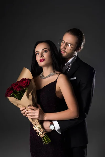 Young Couple Holding Bouquet Red Roses Valentines Day Isolated Grey — Stock Photo, Image