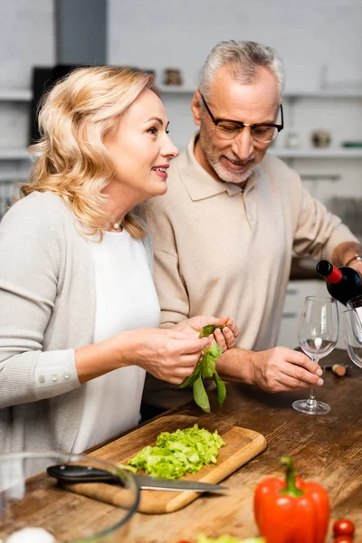 Smiling Man Pouring Wine Woman Holding Green Basil — Stock Photo, Image