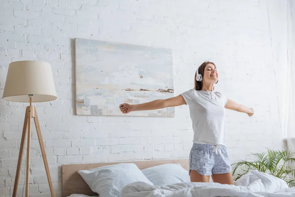 Happy Girl Outstretched Hands Listening Music Bedroom — Stock Photo, Image