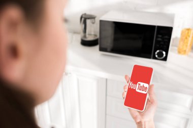 KYIV, UKRAINE - OCTOBER 9, 2019: cropped view of woman holding smartphone with youtube app 