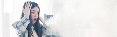 panoramic shot of shocked and attractive woman looking away and touching head 