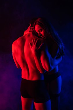 Tutkulu, çıplak seksi genç çift kırmızı ışıkta sarılıyorlar.