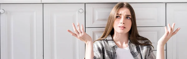 Panoramic Shot Confused Woman Doing Shrug Gesture Kitchen — Stockfoto