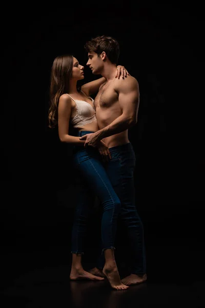 Passionate Undressed Sexy Young Couple Jeans Hugging Isolated Black — Stock Photo, Image