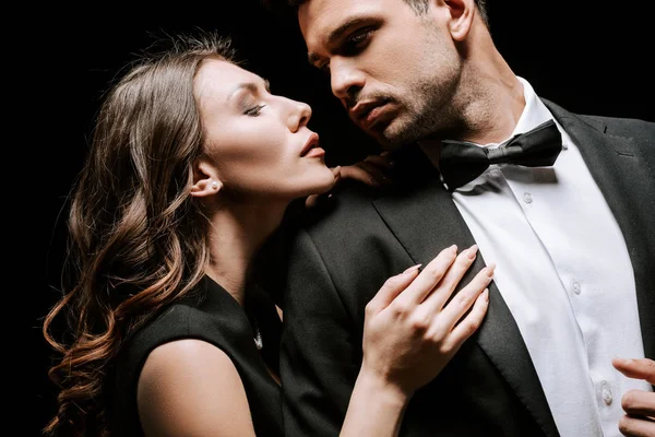 Young Attractive Woman Touching Handsome Man Suit Isolated Black — 스톡 사진