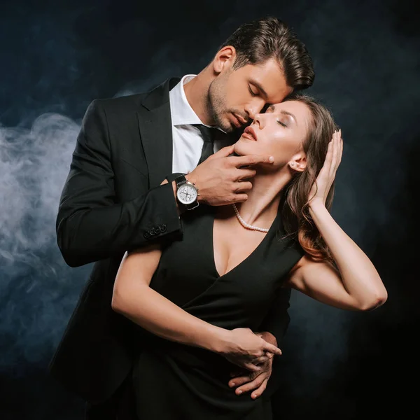 Guapo Hombre Tocando Atractiva Mujer Vestido Negro Con Humo — Foto de Stock