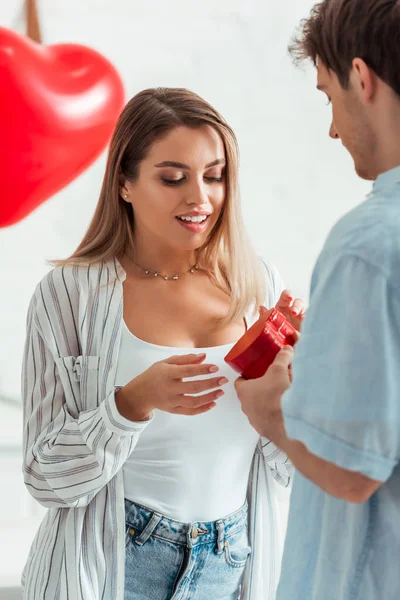 Man Holding Heart Shaped Gift Box Beautiful Girlfriend Valentines Day — Stock Photo, Image