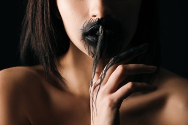 Cropped view of nude woman with black painted lips and hand showing silence gesture isolated on black  