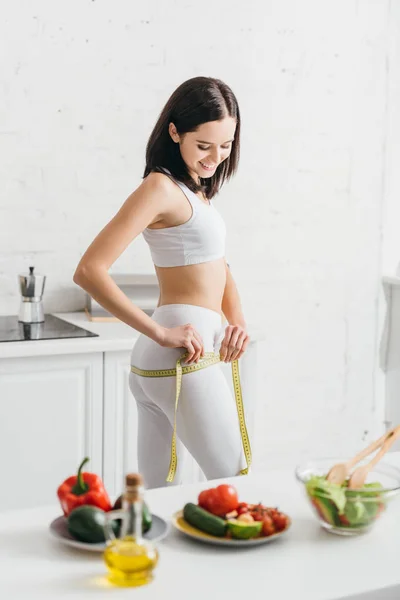 Selective Focus Sportswoman Smiling While Measuring Hips Tape Salad Fresh — 스톡 사진