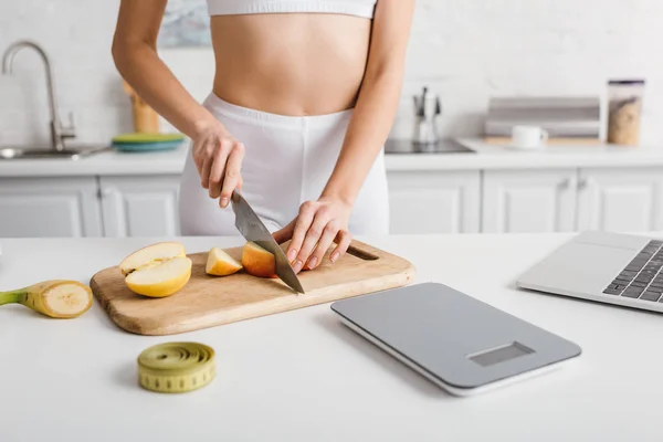 Cropped View Sportswoman Cutting Fruits Laptop Scales Measuring Tape Kitchen — Stock Photo, Image