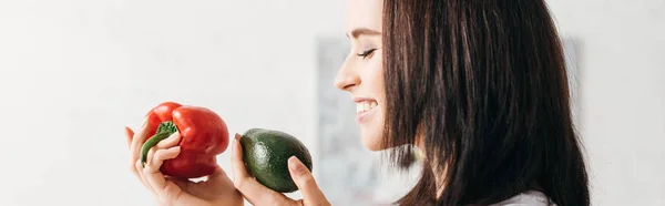 Side View Smiling Girl Holding Bell Pepper Avocado Panoramic Shot — 스톡 사진