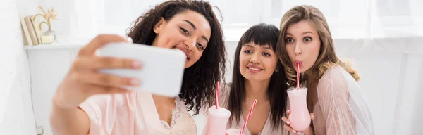 Panoramic Shot Happy Multicultural Girlfriends Bathrobes Drinking Milkshakes While Taking — Stock Photo, Image