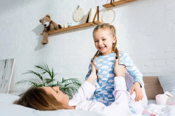 Mother Holding Playing Smiling Daughter Bed — 스톡 사진