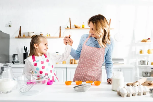 Smiling Mother Holding Hands Cute Daughter Kitchen — Stock Photo, Image