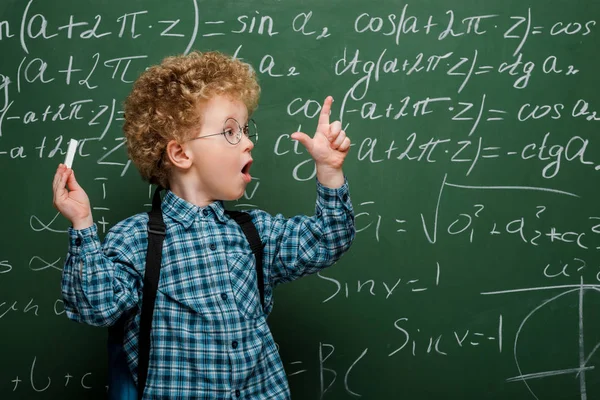 Surprised Kid Glasses Gesturing While Holding Chalk Chalkboard Mathematical Formulas — 스톡 사진