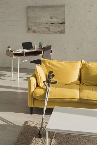 Sunlit Living Room Crutches Yellow Sofa — Stock Photo, Image