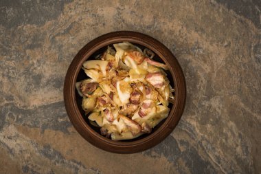 top view of delicious varenyky with cracklings on stone surface