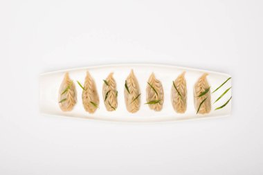 top view of delicious Chinese boiled dumplings on plate on white background