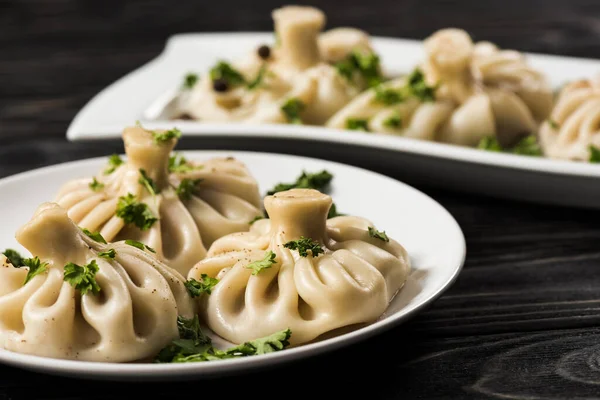 Selective Focus Delicious Khinkali Cilantro Plates Black Wooden Table — Stock Photo, Image