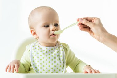 Mother feeding baby with baby nutrition isolated on white