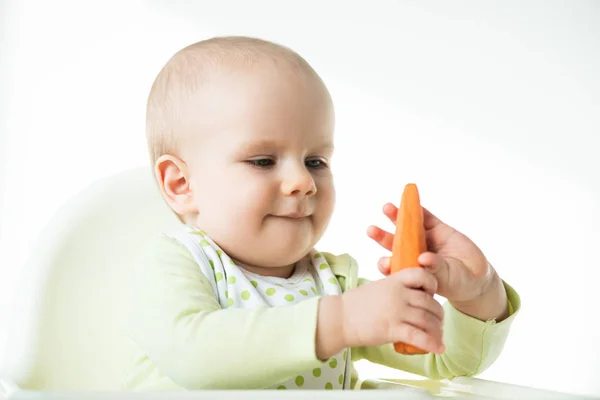 Adorable Baby Holding Carrot While Sitting Feeding Chair Isolated White — ストック写真