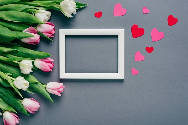 Top View White Empty Frame Paper Hearts Tulips Grey Background — Stock Photo, Image
