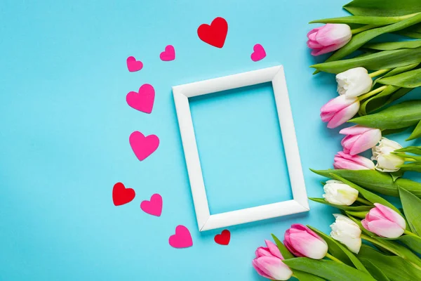 Top View White Empty Frame Paper Hearts Tulips Blue Background — Stock Photo, Image