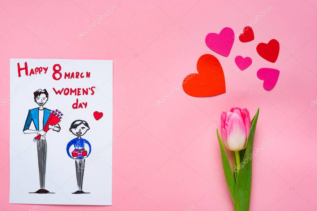Top view of greeting card with drawing and 8 march happy womens day lettering and tulip with paper hearts on pink background