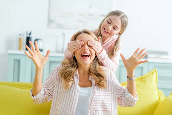 Happy Kid Covering Eyes Surprised Mother Gesturing Living Room — 스톡 사진