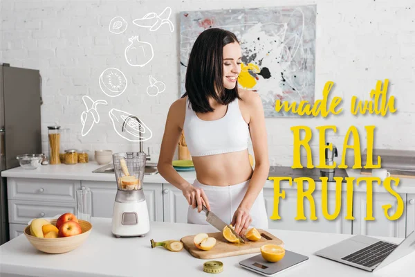 Smiling Fit Sportswoman Looking Laptop While Cutting Fruits Blender Kitchen — Stock Photo, Image