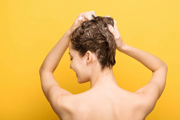 Vista Posterior Mujer Lavando Cabello Con Champú Sobre Fondo Amarillo — Foto de Stock