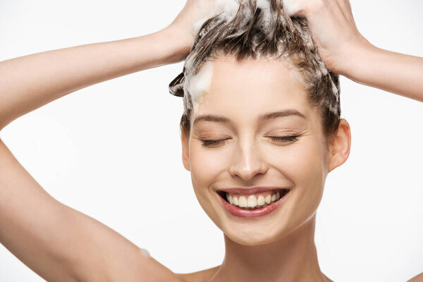 happy girl with closed eyes washing hair isolated on white