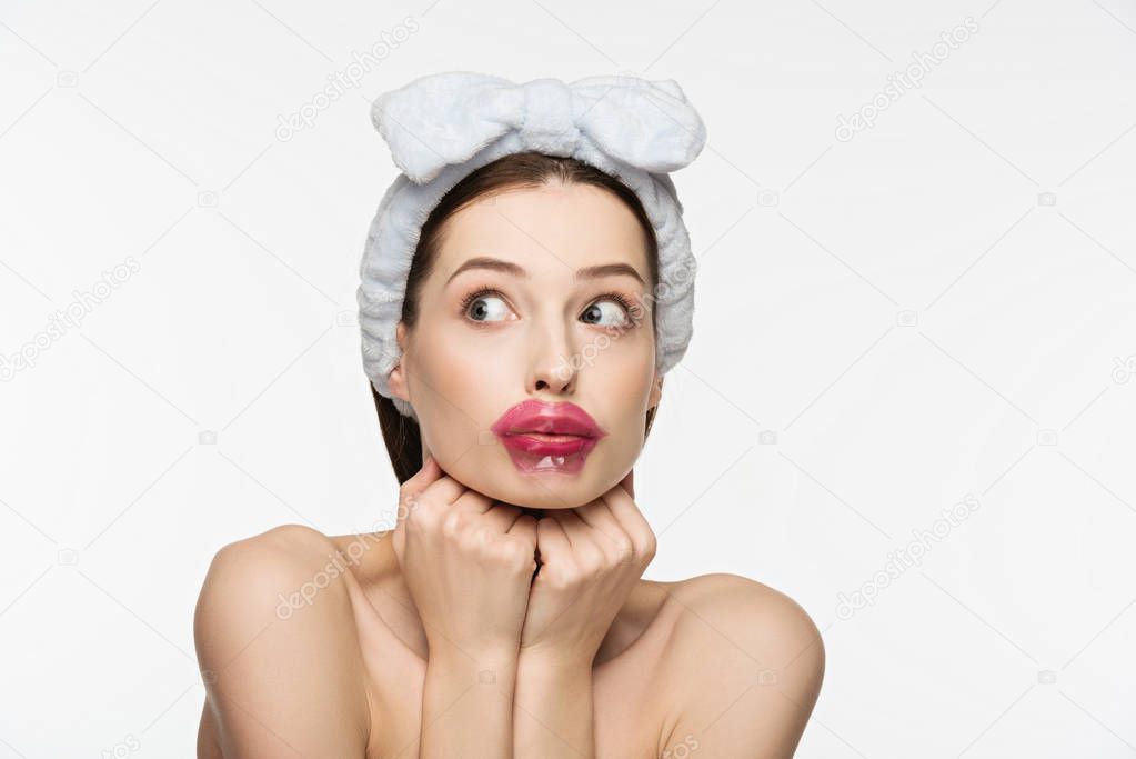 scared girl with collagen patch on lips looking away isolated on white