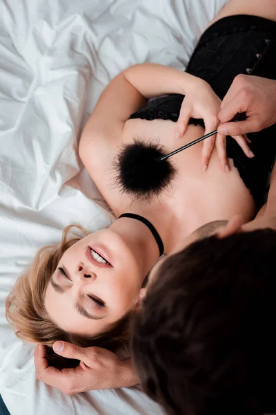 Top View Dominant Man Holding Tickler Submissive Woman Closed Eyes — стоковое фото