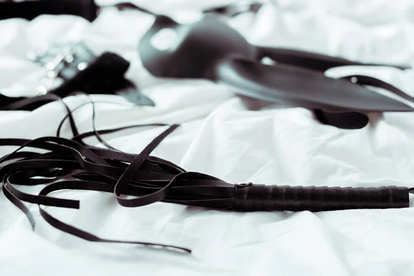 Selective Focus Black Flogging Whip White Bedding — Stock Photo, Image