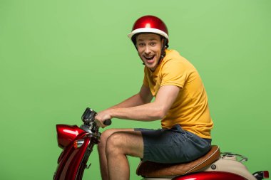 side view of crazy delivery man in yellow uniform on scooter isolated on green clipart