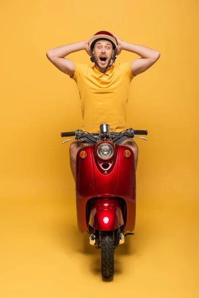 Shocked Delivery Man Yellow Uniform Riding Scooter Yellow Background — Stock Photo, Image