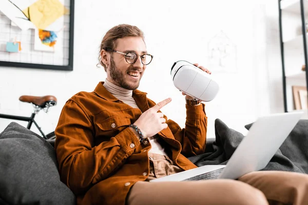 Cheerful Artist Pointing Virtual Reality Headset While Having Video Call — Stock Photo, Image