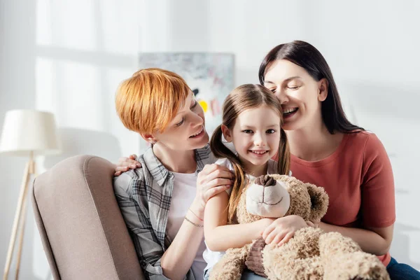 Sonriente Niño Con Oso Peluche Mirando Cámara Cerca Felices Padres —  Fotos de Stock