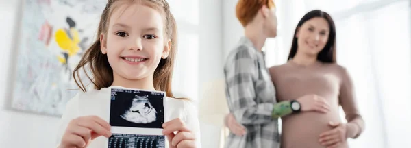 Selective Focus Smiling Kid Holding Ultrasound Scan Baby While Woman — Stock Photo, Image